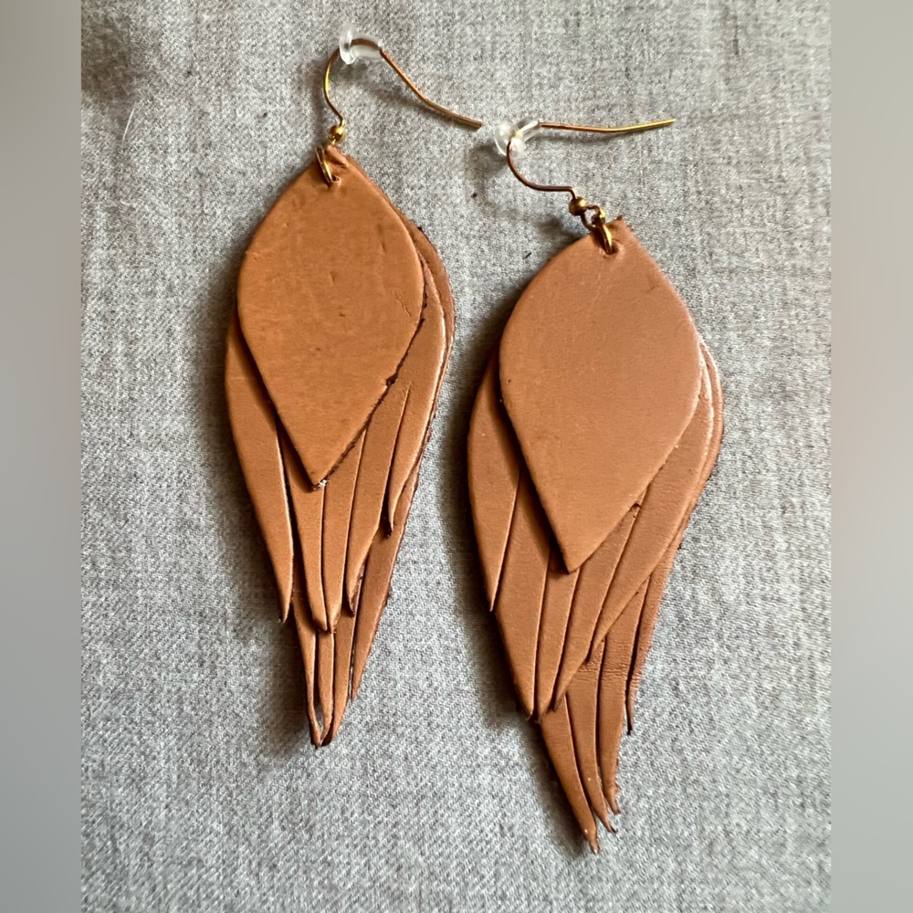 Noonday Collection brown leather Angel Wing earrings.